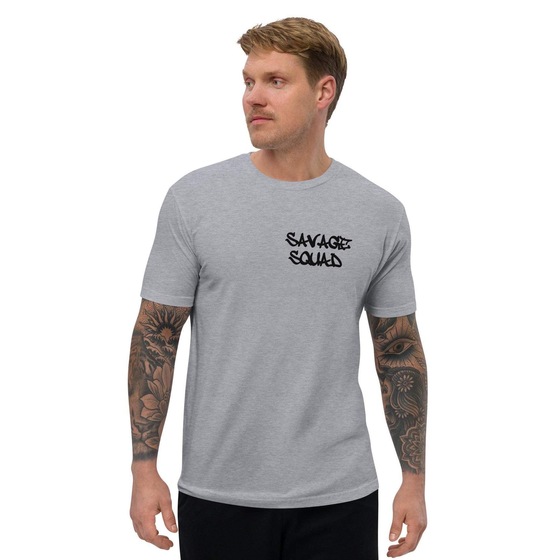 Man wearing gray logo tee with "Savage Squad" text, showcasing casual style and fitted design.