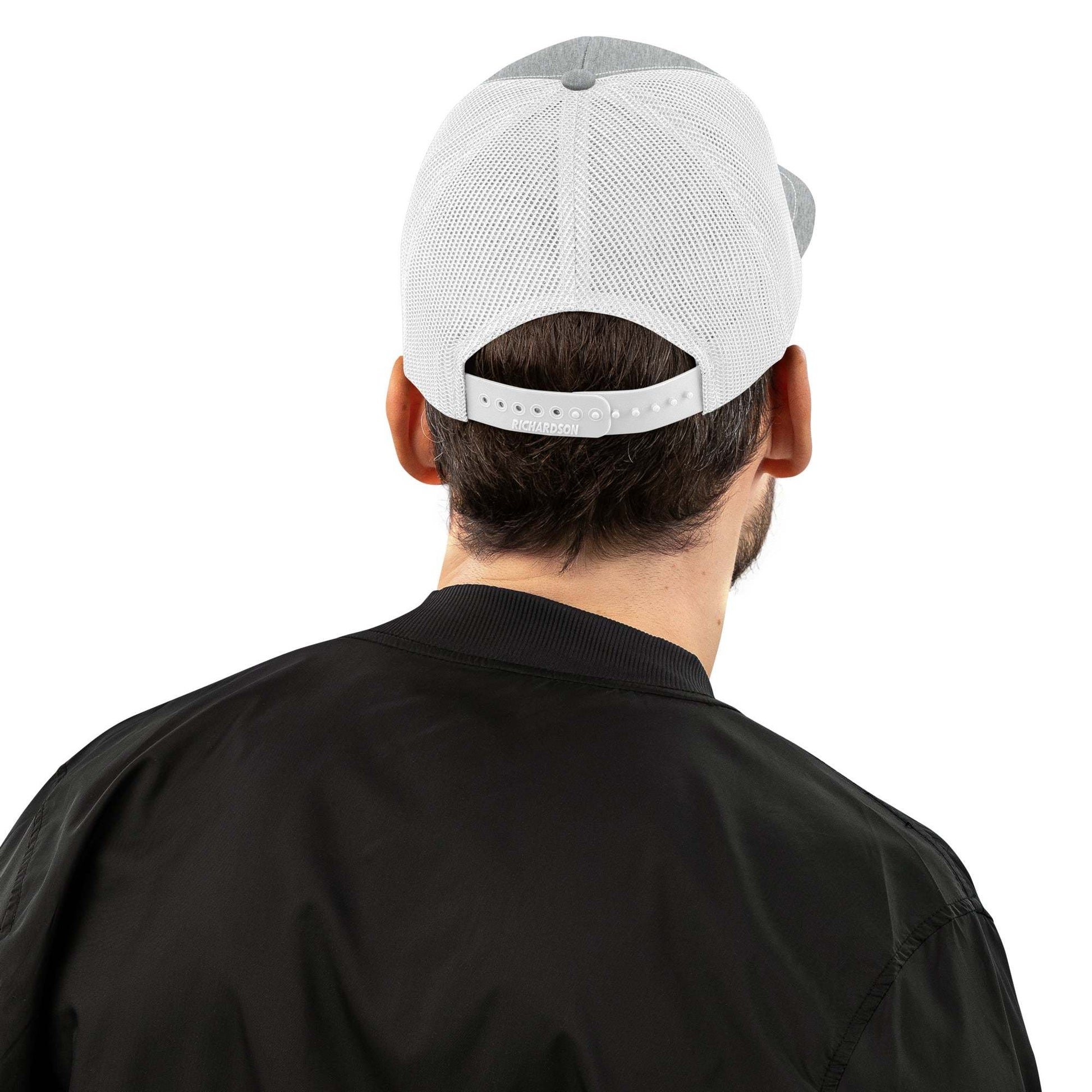 Man wearing a white Savage Squad Snapback, showing its adjustable mesh back.